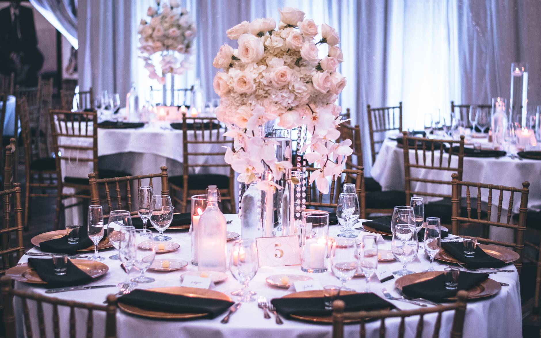 pink and white roses centerpiece on top of table