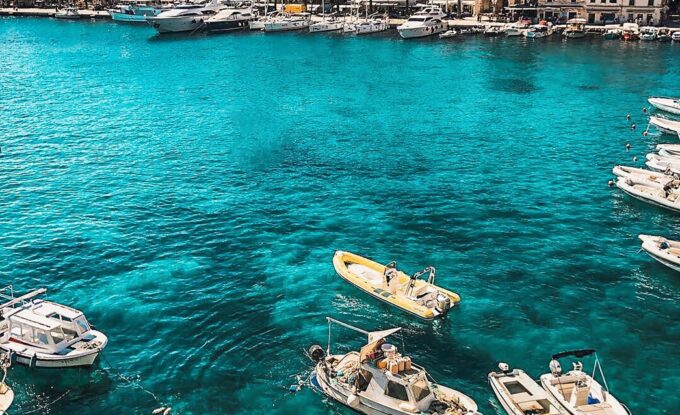 white boats on body of water