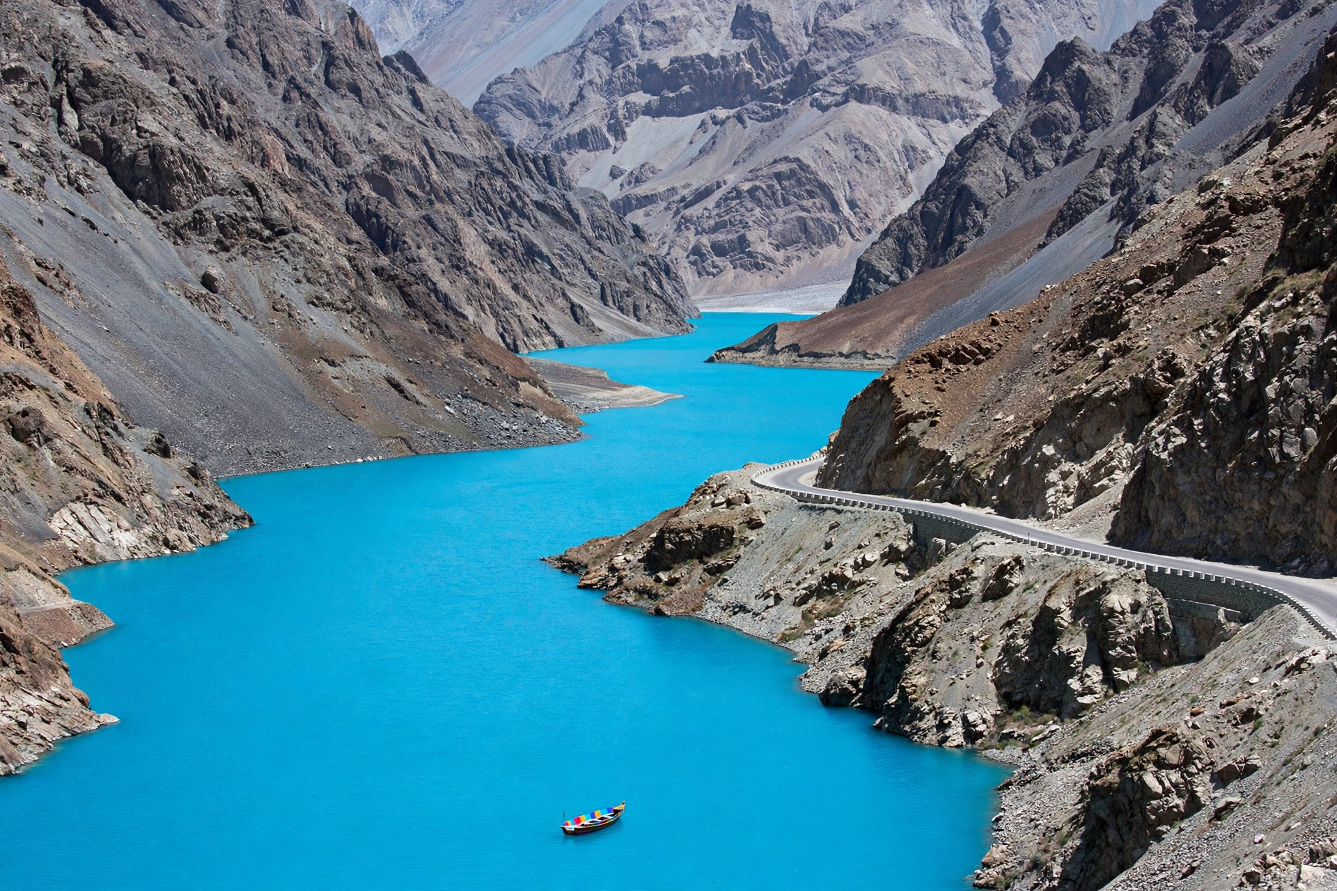 Electric turquoise Attabad Lake between steep Karakoram rock walls
