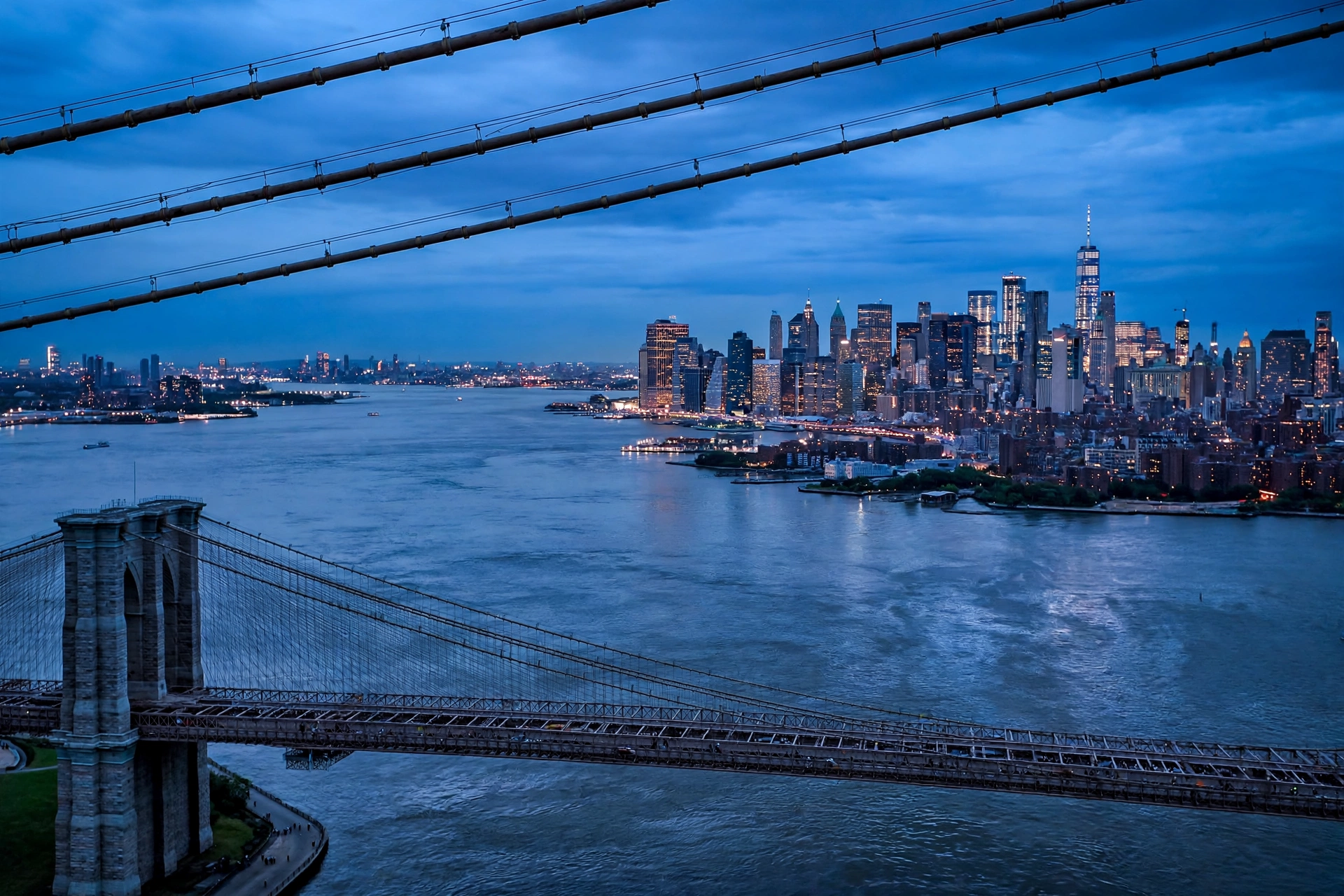 New York City skyline at dusk with yellow cabs and the Brooklyn Bridge